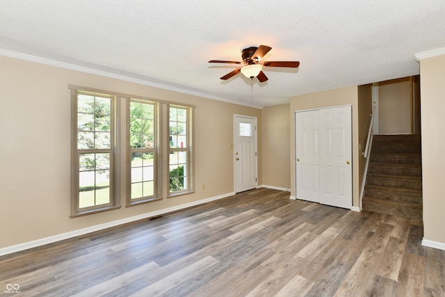 524 Concord Ct, Fishers, IN 46038 - foyer with a ceiling fan, wood finished floors, ornamental molding, stairs, and a textured ceiling