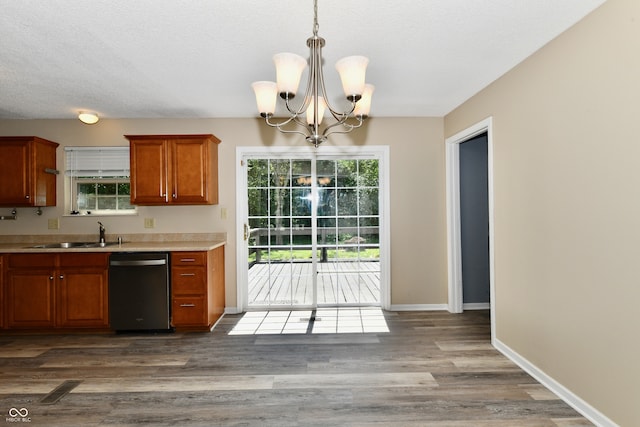 524 Concord Ct, Fishers, IN 46038 - kitchen featuring dishwasher, a chandelier, brown cabinetry, light countertops, and wood finished floors