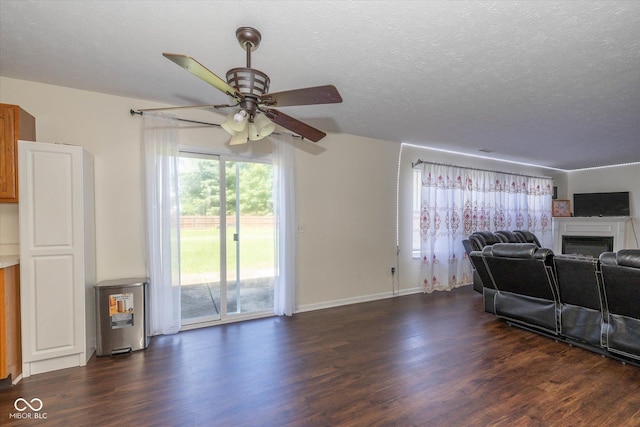 3624 Newberry Rd, Plainfield, IN 46168 - living area with a ceiling fan, dark wood finished floors, a fireplace, and a textured ceiling