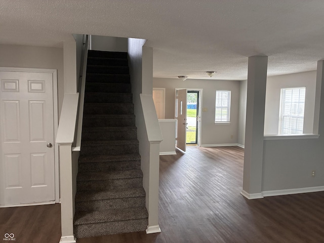 3129 Everbloom Way, Indianapolis, IN 46217 - stairway featuring wood finished floors and a textured ceiling