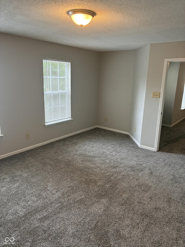 3129 Everbloom Way, Indianapolis, IN 46217 - unfurnished room with dark colored carpet and a textured ceiling