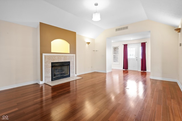 3244 Skyview Ct, Columbus, IN 47203 - unfurnished living room with lofted ceiling, a tile fireplace, and wood finished floors