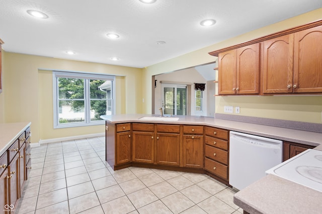 3244 Skyview Ct, Columbus, IN 47203 - kitchen with dishwasher, light countertops, a peninsula, light tile patterned flooring, and recessed lighting
