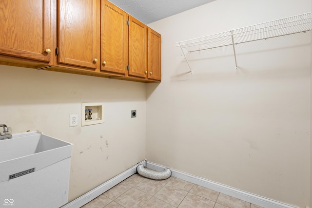 3244 Skyview Ct, Columbus, IN 47203 - laundry area with cabinet space, electric dryer hookup, washer hookup, and light tile patterned flooring