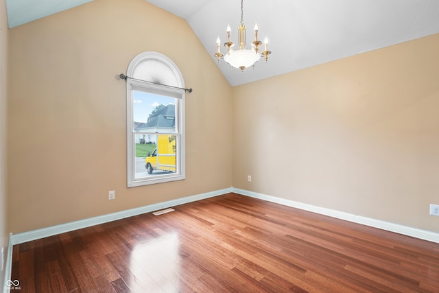 3244 Skyview Ct, Columbus, IN 47203 - empty room with vaulted ceiling, a chandelier, and wood finished floors