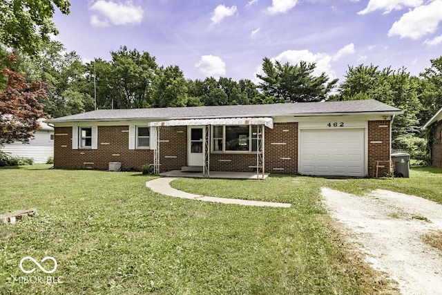 462 Woodview Dr, Noblesville, IN 46060 - ranch-style house with dirt driveway, an attached garage, a front yard, and brick siding