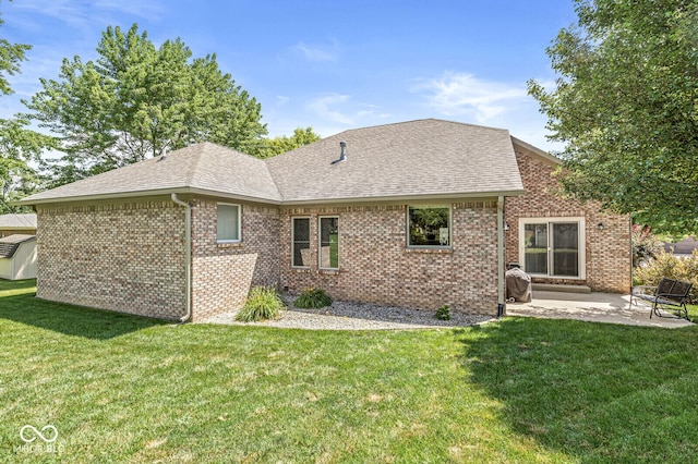 11 Stratford Way, Danville, IN 46122 - back of property featuring roof with shingles, a patio, a lawn, and brick siding