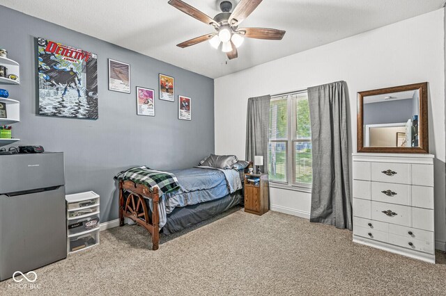 11 Stratford Way, Danville, IN 46122 - bedroom featuring freestanding refrigerator, carpet floors, and a ceiling fan