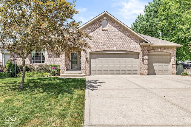 11 Stratford Way, Danville, IN 46122 - view of front of property featuring a garage, brick siding, driveway, and a front yard