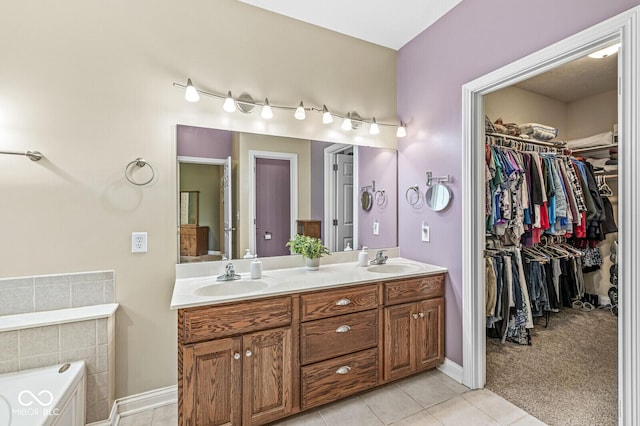 11 Stratford Way, Danville, IN 46122 - bathroom featuring double vanity, a garden tub, tile patterned flooring, and a walk in closet