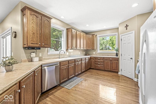 11 Stratford Way, Danville, IN 46122 - kitchen with dishwasher, freestanding refrigerator, light wood-style floors, light countertops, and brown cabinetry