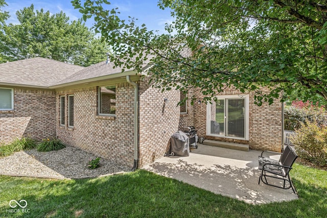 11 Stratford Way, Danville, IN 46122 - back of property featuring roof with shingles, brick siding, and a patio area
