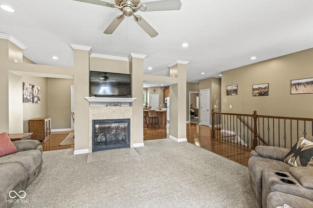 11 Stratford Way, Danville, IN 46122 - living room featuring a ceiling fan, carpet flooring, crown molding, recessed lighting, and a fireplace