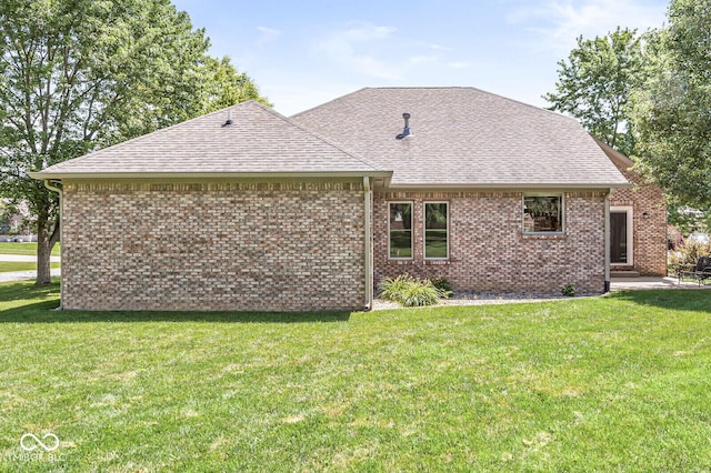 11 Stratford Way, Danville, IN 46122 - back of property featuring roof with shingles, a lawn, and brick siding
