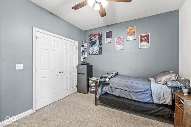 11 Stratford Way, Danville, IN 46122 - bedroom featuring freestanding refrigerator, carpet floors, a closet, and a ceiling fan