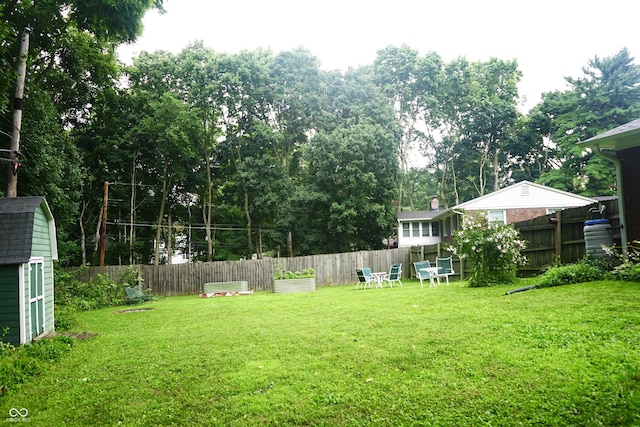 7780 Cree Trl, Indianapolis, IN 46250 - fenced yard with a storage unit and view of wooded area