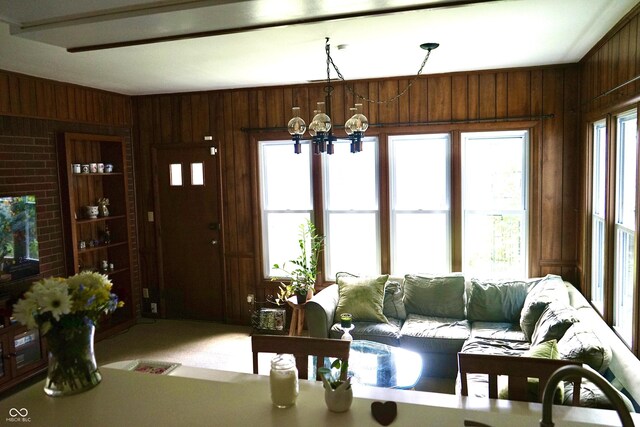 7780 Cree Trl, Indianapolis, IN 46250 - living area with wooden walls, a chandelier, and carpet flooring