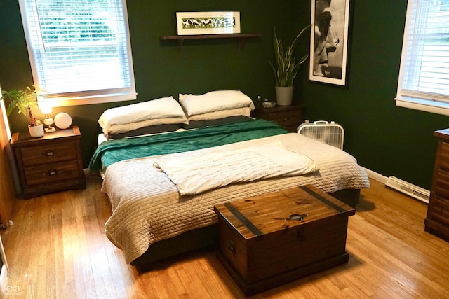 7780 Cree Trl, Indianapolis, IN 46250 - bedroom with wood finished floors and a baseboard radiator