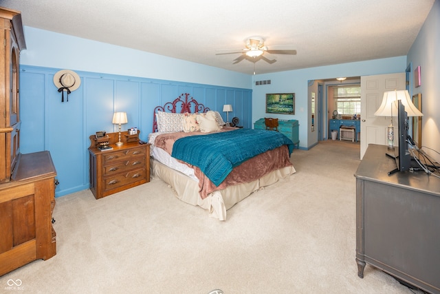 12602 Lockerbie Cir, Carmel, IN 46033 - bedroom featuring light colored carpet, a ceiling fan, and a decorative wall