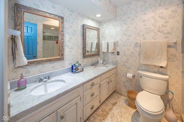 12602 Lockerbie Cir, Carmel, IN 46033 - full bathroom with double vanity, wallpapered walls, and a shower