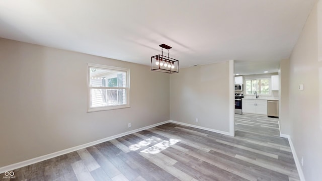830 Stardust Blvd, Noblesville, IN 46060 - unfurnished dining area with light wood-type flooring and baseboards