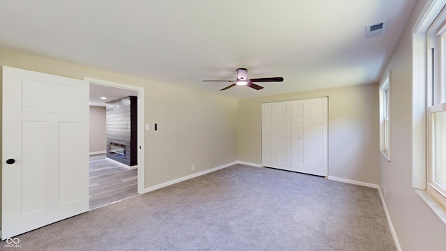 830 Stardust Blvd, Noblesville, IN 46060 - unfurnished bedroom featuring carpet flooring, a closet, multiple windows, and a ceiling fan