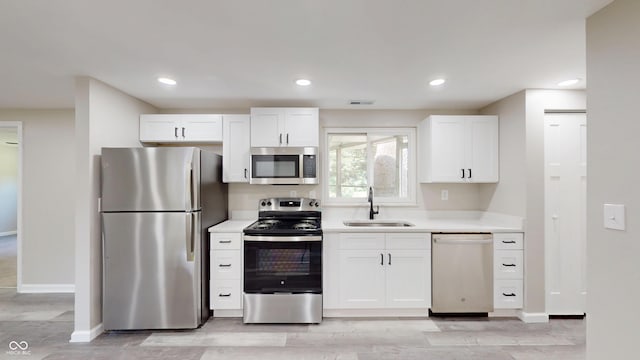 830 Stardust Blvd, Noblesville, IN 46060 - kitchen with stainless steel appliances, light countertops, white cabinets, light wood-type flooring, and recessed lighting