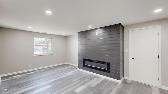 830 Stardust Blvd, Noblesville, IN 46060 - unfurnished living room with a fireplace, wood finished floors, and recessed lighting