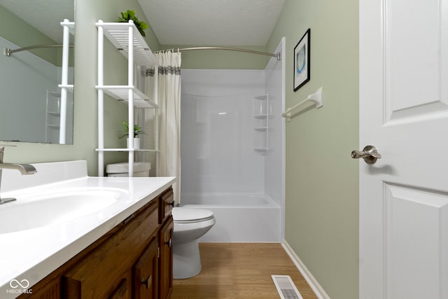 7683 Madden Dr, Fishers, IN 46038 - full bathroom featuring vanity, wood finished floors, shower / bath combo, and a textured ceiling