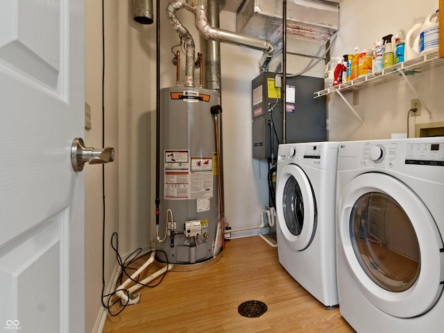 7683 Madden Dr, Fishers, IN 46038 - laundry room featuring water heater, washing machine and clothes dryer, and light wood finished floors