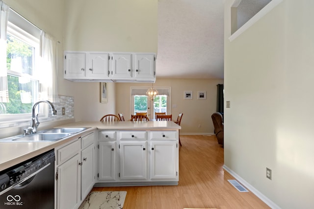 7683 Madden Dr, Fishers, IN 46038 - kitchen with black dishwasher, white cabinets, a peninsula, light wood-type flooring, and a textured ceiling