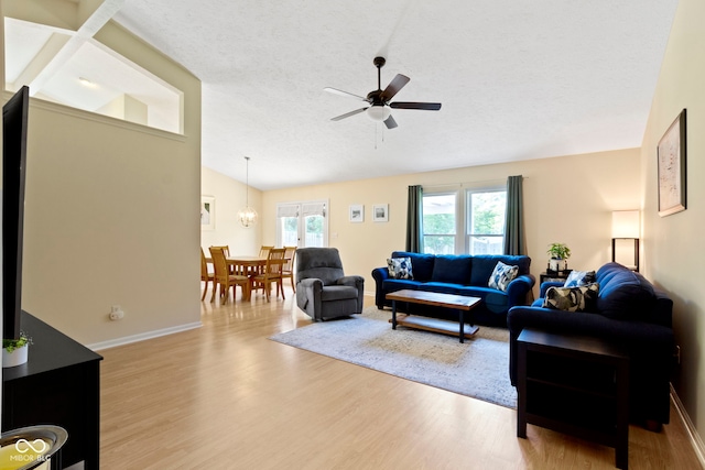 7683 Madden Dr, Fishers, IN 46038 - living room featuring vaulted ceiling, wood finished floors, a ceiling fan, and a textured ceiling