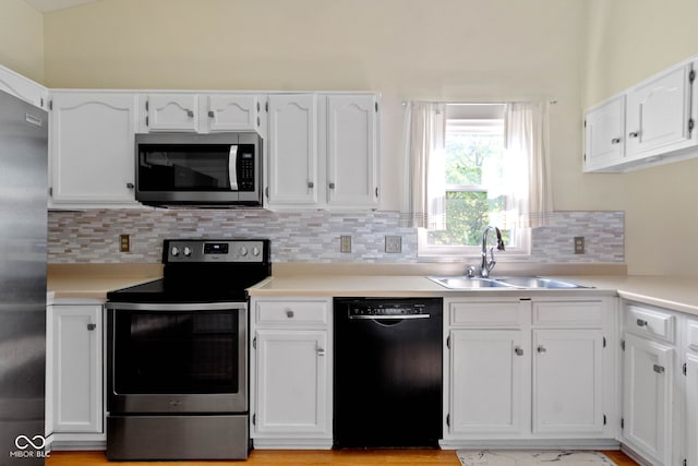 7683 Madden Dr, Fishers, IN 46038 - kitchen featuring appliances with stainless steel finishes, white cabinetry, decorative backsplash, and light countertops