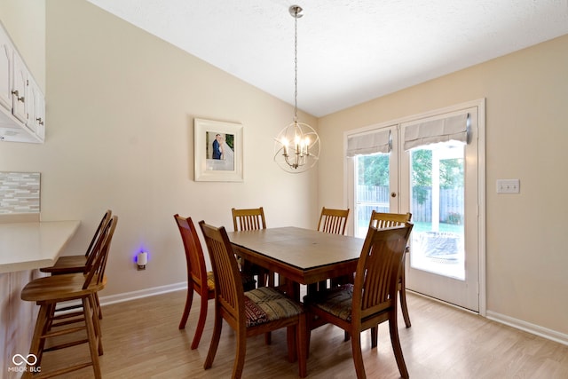 7683 Madden Dr, Fishers, IN 46038 - dining room featuring light wood-style floors, a chandelier, vaulted ceiling, and french doors