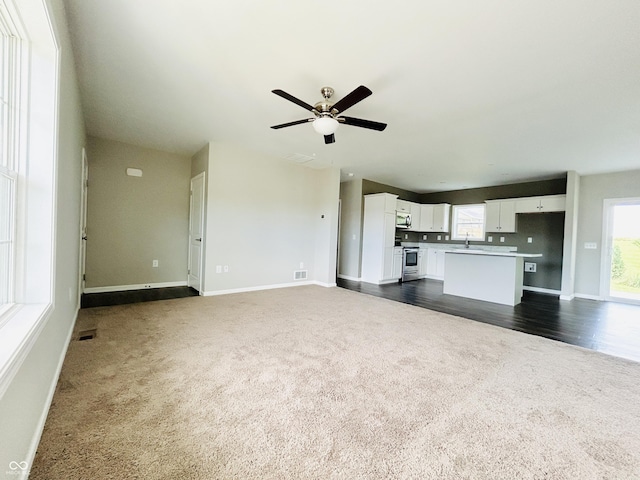 10 Doe Creek Cir, Cloverdale, IN 46120 - unfurnished living room with dark carpet and ceiling fan