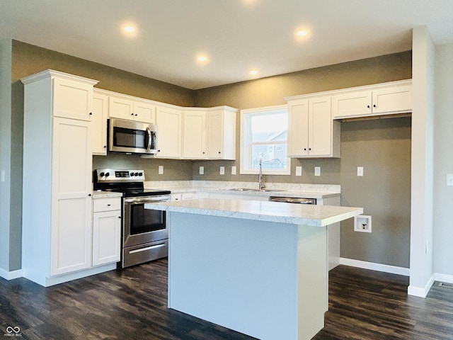 10 Doe Creek Cir, Cloverdale, IN 46120 - kitchen featuring stainless steel appliances, dark wood-type flooring, a kitchen island, white cabinetry, and light countertops