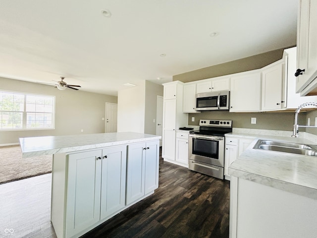 10 Doe Creek Cir, Cloverdale, IN 46120 - kitchen featuring stainless steel appliances, a center island, dark wood-style flooring, white cabinets, and light countertops