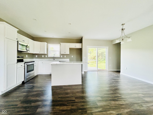 10 Doe Creek Cir, Cloverdale, IN 46120 - kitchen featuring stainless steel range with electric stovetop, a center island, dark wood-style flooring, and white cabinets
