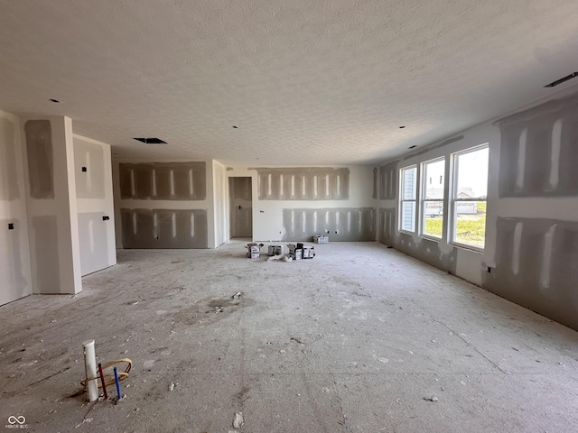 9417 Crimson Cir, Lapel, IN 46051 - unfurnished living room with a textured ceiling and electric panel