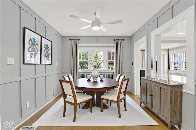6711 Lafayette Rd, Indianapolis, IN 46278 - dining area with a decorative wall, ceiling fan, and light wood-style floors