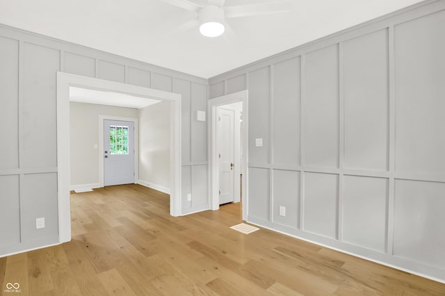 6711 Lafayette Rd, Indianapolis, IN 46278 - interior space featuring a decorative wall, light wood-style flooring, and a ceiling fan
