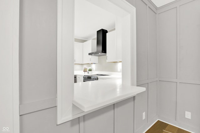 6711 Lafayette Rd, Indianapolis, IN 46278 - kitchen with wall chimney exhaust hood, a decorative wall, stainless steel electric stove, light countertops, and white cabinetry
