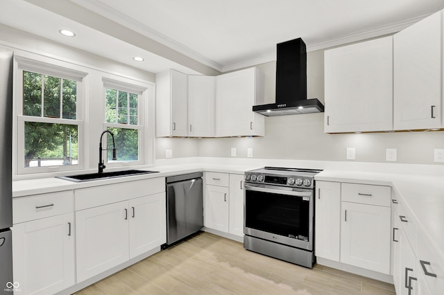 6711 Lafayette Rd, Indianapolis, IN 46278 - kitchen with wall chimney range hood, stainless steel appliances, crown molding, white cabinetry, and light countertops
