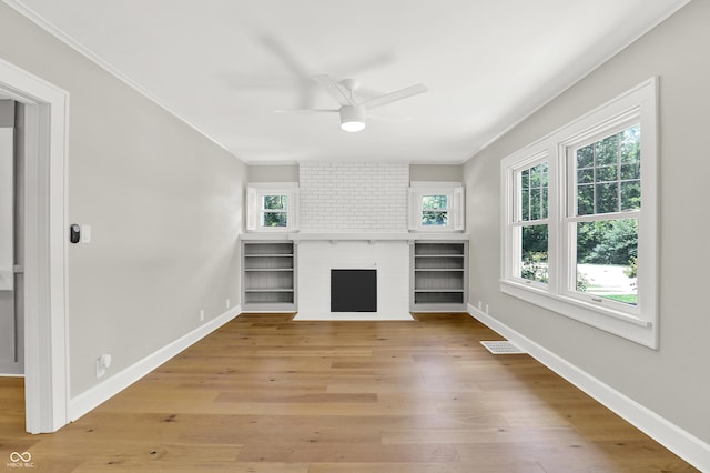 6711 Lafayette Rd, Indianapolis, IN 46278 - unfurnished living room with ceiling fan, light wood-type flooring, a brick fireplace, and ornamental molding