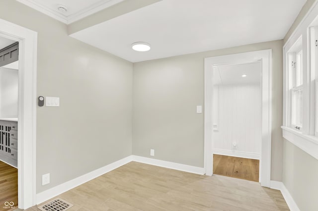 6711 Lafayette Rd, Indianapolis, IN 46278 - spare room featuring a smoke detector, light wood-style flooring, and crown molding