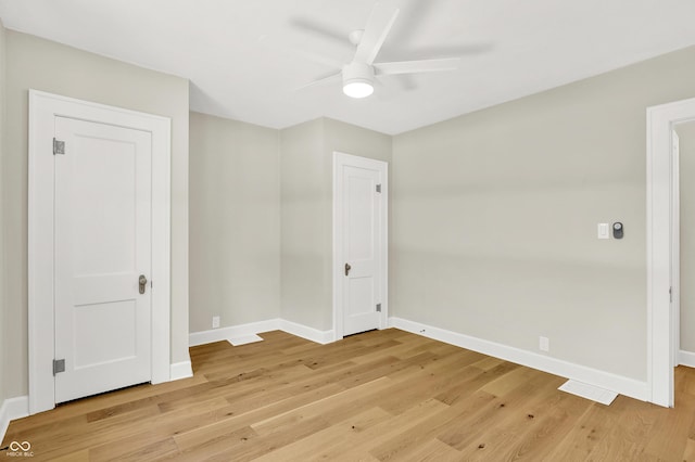 6711 Lafayette Rd, Indianapolis, IN 46278 - unfurnished bedroom featuring light wood-type flooring and ceiling fan