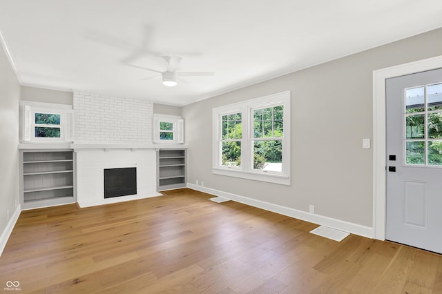 6711 Lafayette Rd, Indianapolis, IN 46278 - unfurnished living room featuring a ceiling fan, light wood-type flooring, and a brick fireplace
