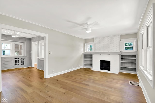 6711 Lafayette Rd, Indianapolis, IN 46278 - unfurnished living room with a ceiling fan, light wood-style flooring, a fireplace, and crown molding