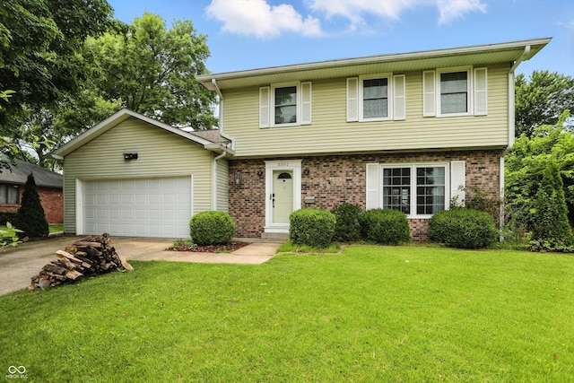 3302 Beech Dr, Columbus, IN 47203 - colonial-style house with concrete driveway, a garage, brick siding, and a front yard