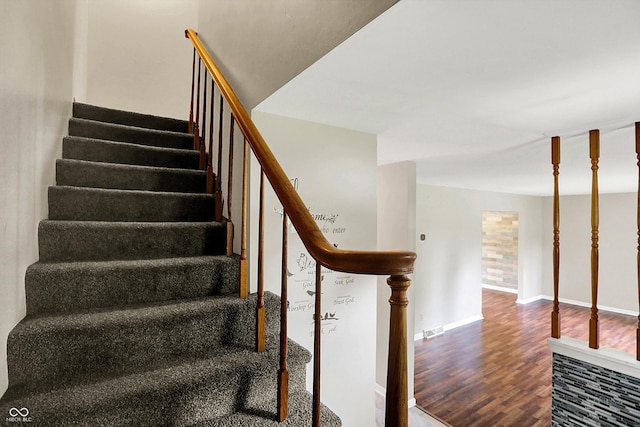 3302 Beech Dr, Columbus, IN 47203 - staircase with wood finished floors and baseboards